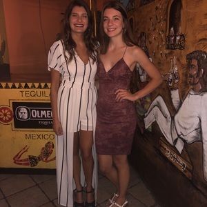 Black and white striped jumpsuit. Has shorts underneath with a cape at the waist